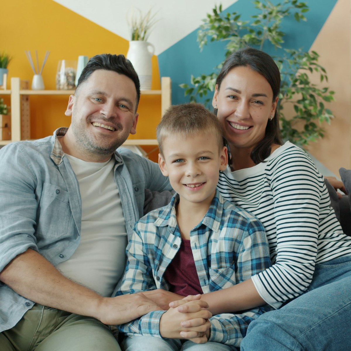 A happy family relaxing together on the sofa at home